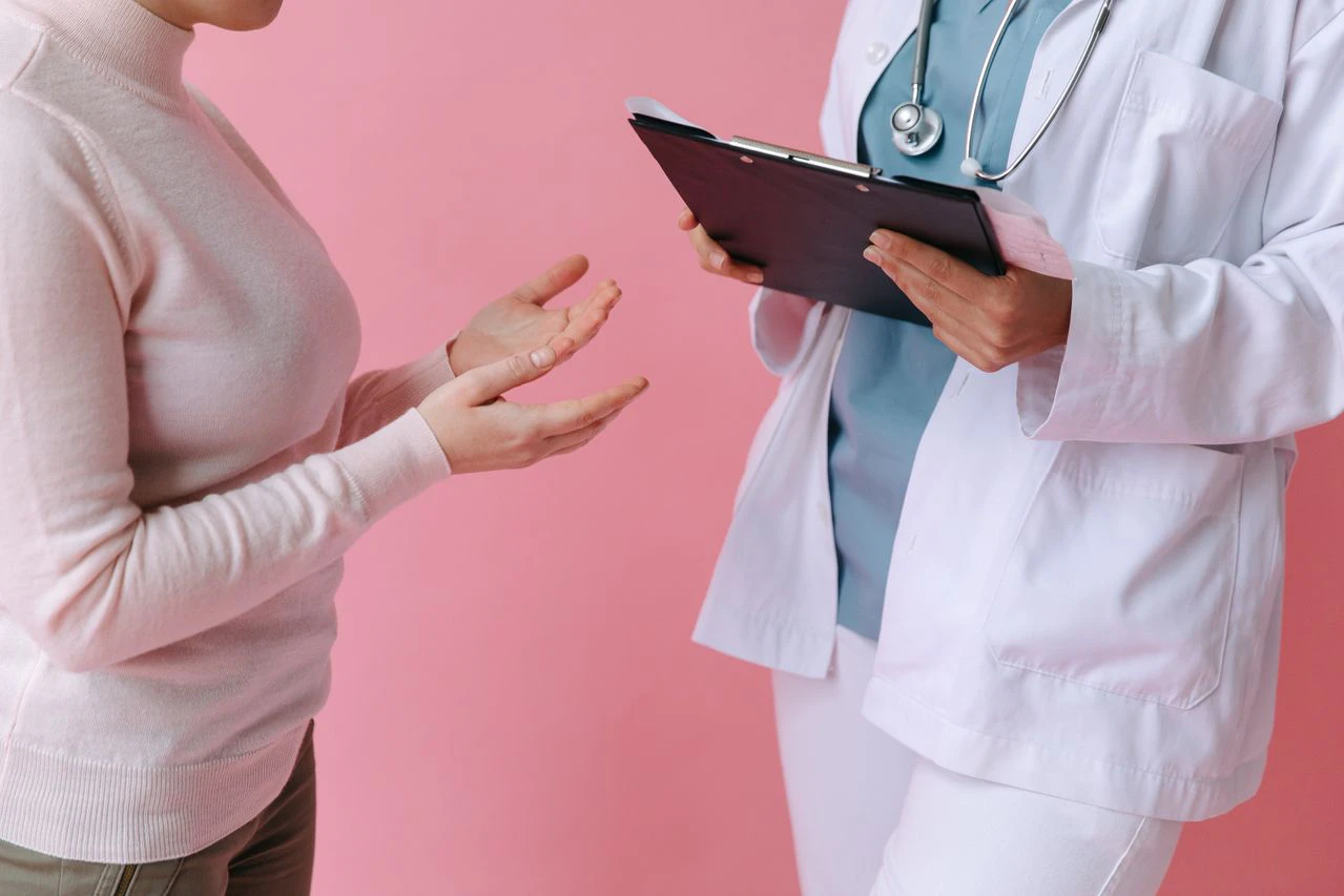 Patient discussing liposuction, tummy tuck surgery and aftercare with a specialist team in a CQC-registered hospital consultation.